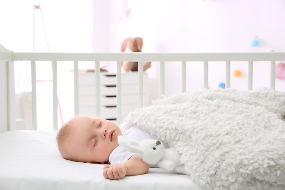 when can baby sleep with blanket
