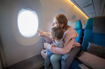 how to hold infant on airplane